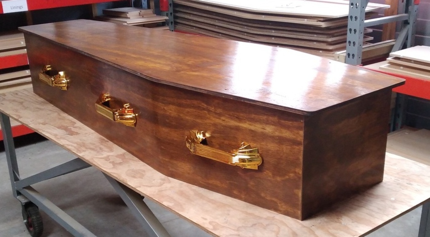 Red Coffin at funeral with flowers